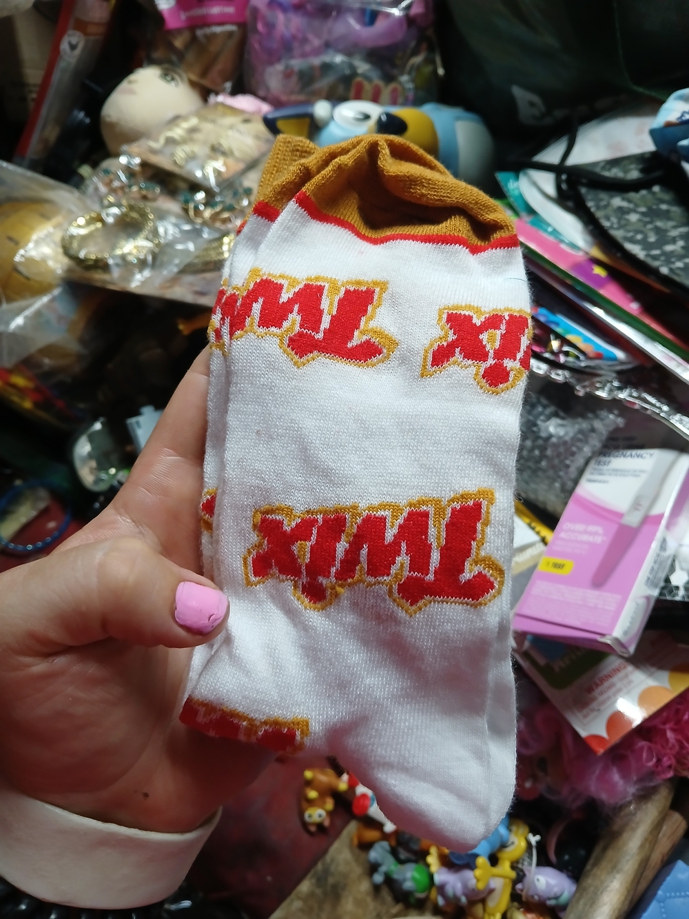 white Twix novelty crew socks featuring the iconic candy bar logo and bold yello